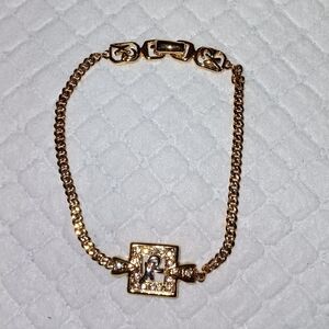 Nina Ricci Rhinestone Logo Gold Tone Bracelet